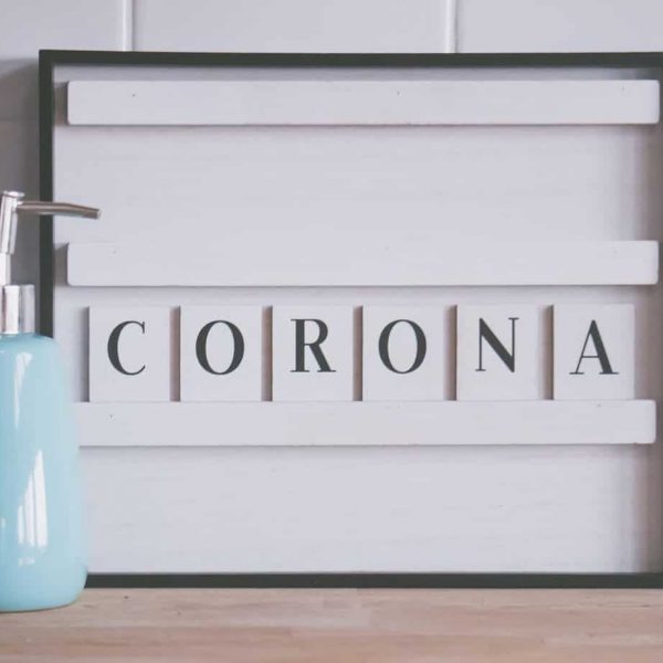 Canva – Dispenser with soap and Corona word Canva - Dispenser with soap and Corona word